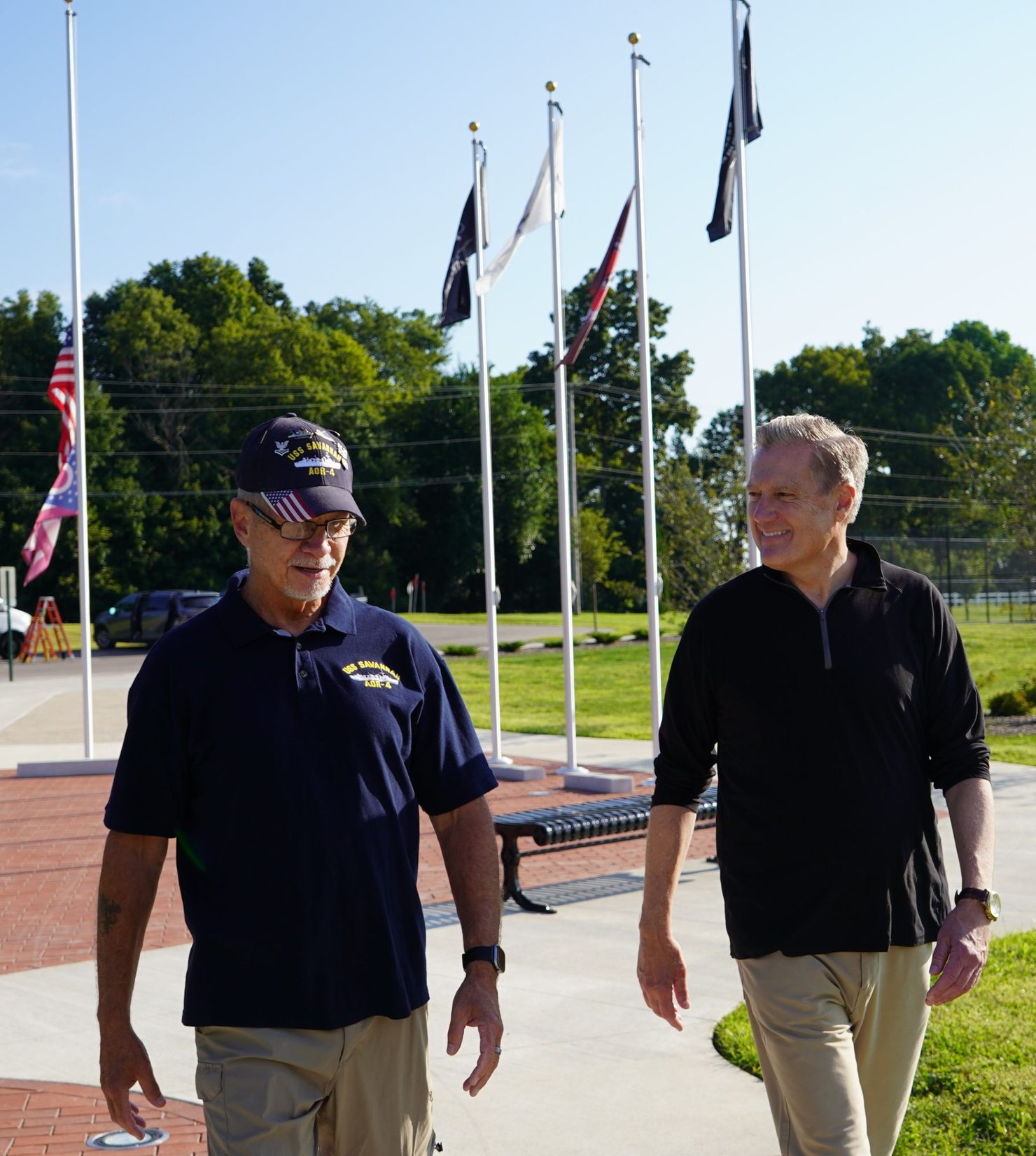 Mike Turner walking with a veteran at a veterans memorial